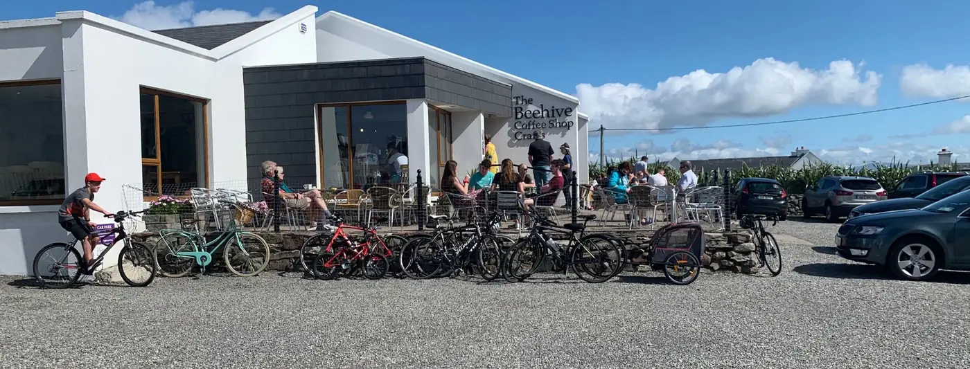 The Beehive Coffee Shop and Crafts in Keel with the outdoor seating full on a sunny day